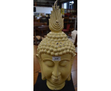 A ceramic Buddha head, pale lemon glaze, approx 50cm high