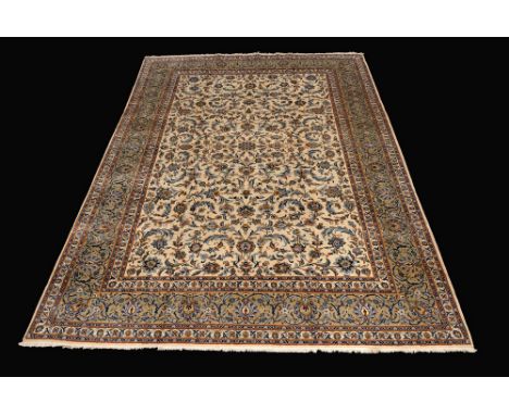 A Kashan carpet, the cream ground with flowers and foliage in tones of crimson and cerulean, 414cm x 300cm