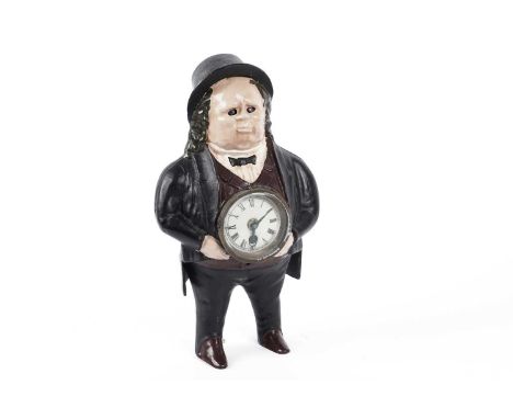 A vintage novelty table clock, modelled as the figure of John Bull, with inset cream enamel Roman dial to centre, 35cms high.