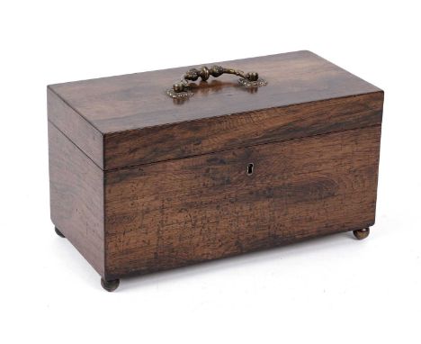 A Victorian mahogany tea caddy, with ornate brass swing handle to its hinged lid, opening to reveal an interior divided into 