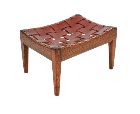 A George V oak and leather stool, by Arthur Simpson of Kendal, c.1930, rectangular with brass studded leather lattice straps,