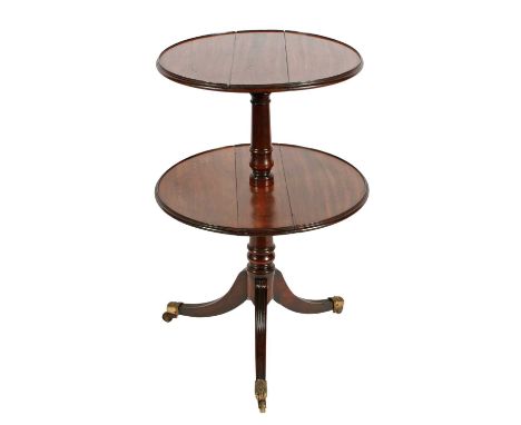 A Regency mahogany two-tier drop leaf dumb waiter, c.1820, the graduated circular tiers each have a low raised edge and a hin