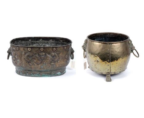A Victorian brass jardiniere or coal scuttle, of squat cylindrical form, mounted with twin lions head and ring pull handles, 