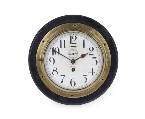 A brass bulkhead timepiece, with white enamel Arabic dial with subsidiary seconds dial with obscured maker's mark, with singl