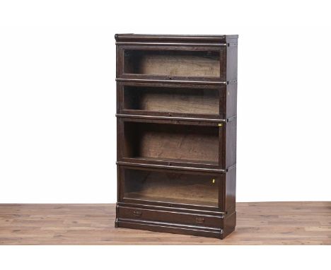Globe Wernicke: An early 20th Century oak sectional bookcase, with four glazed up and over doors (one missing glazed panel) a