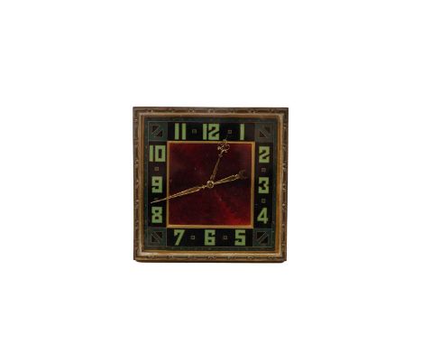 An Art Deco gilt cased travel/desk clock, with green Arabic dial surrounding a red enamel face, with scrolling and crescent m