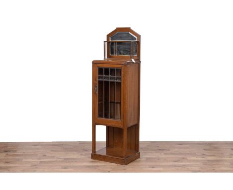 An early 20th Century oak Biedermeier style display cabinet, with bevelled mirror gallery above bevelled glazed panel door op