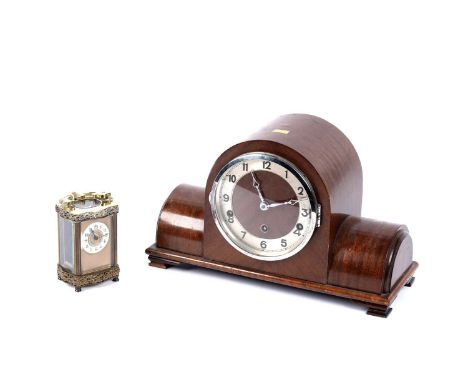A late 19th Century brass carriage clock, with white enamel Arabic dial, platform lever escapement, the case with scrolling d