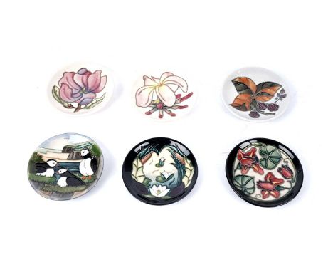 A collection of Moorcroft ceramic pin dishes, including: a 'Puffins' pattern pin dish, designed by Carole Lovatt; a 'Bramble'