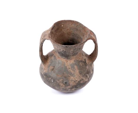 A terracotta jar, probably Chinese Neolithic Qijia culture, 1st century BC, with double loop handles and traces of iron-red a