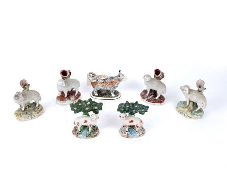 Four Staffordshire spill figures; together with two other ceramic items, a Staffordshire cow creamer; and a pair of Delft she