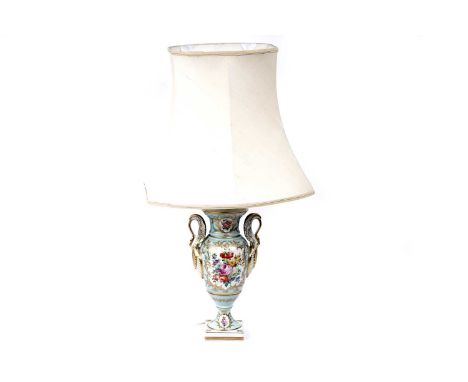 A 20th Century French twin handled urn vase table lamp, with over-painted floral decoration surrounded by scrolling gilt bord