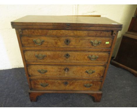 Edwardian walnut gentleman's dressing chest, fold over top flanked by lopers, above four graduated drawers on ogee bracket fe