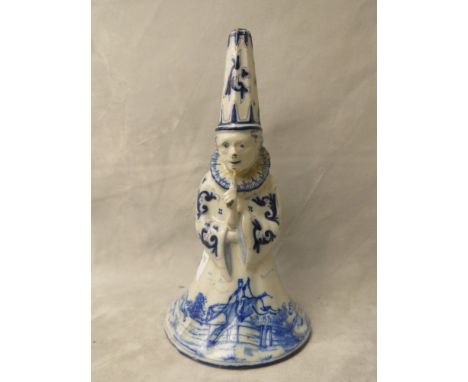 Late 18th/19th century Dutch Delft pottery figural bell in the form of a clown, decorated in blue and white with a hunting sc