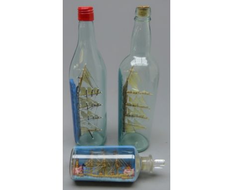 Two four masted ships models in bottles, 'Loch Lomond ' and another and a small diorama of a three master with two steam tugs