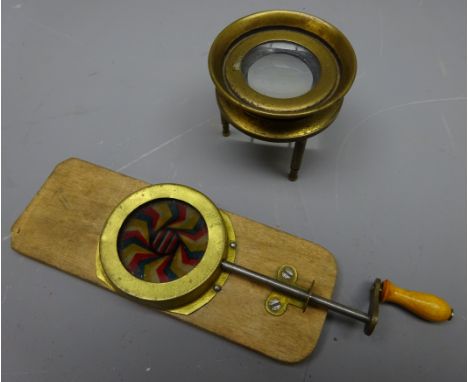 Victorian chromotropic mechanical magic lantern slide L15cm and a maritime small brass chart table three-legged magnifying gl