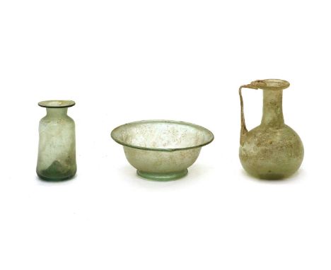 Three Roman green glass vessels, comprising; a footed bowl, 10cm diam., a flask with strap handle, 9.5cm high, and a vase wit