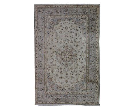 A Persian Kashan carpet, 20th century, woven with scrolling floral and foliate motifs on a pale ground, 355 x 248Condition re