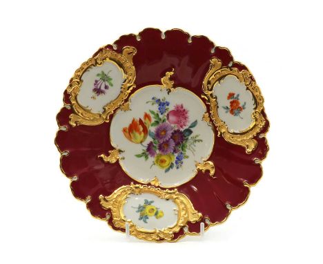 A Meissen porcelain cabinet plate, early 20th century, of shaped circular form, centred with painted floral decoration, withi