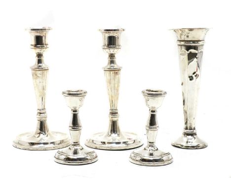 A pair of silver candlesticks, with plain tapering column, by W I Broadway &amp; Co, Birmingham 1954, 20cm high, a smaller pa