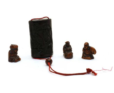 Three Japanese wood netsuke, 20th century, one seated, one holding a kiseruzutsu, one with a large bag, 4cm high, and a wood 