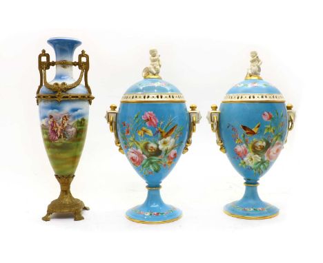 A pair of late 19th century French porcelain vase and covers, each cover pierced border and putti finial, the body painted wi