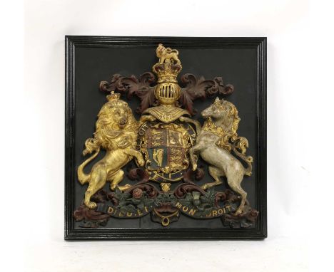 A cold painted cast iron crest of "Royal arms", 19th century, mounted on a framed ebonised panel, 53cm wide, 57cm highConditi