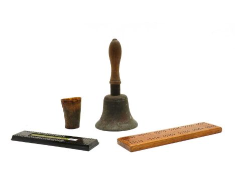 A 'Fiddian' school bell, 26cm high, together with a horn dice shaker/beaker, 8.5cm high, a wooden cribbage board, and a simil