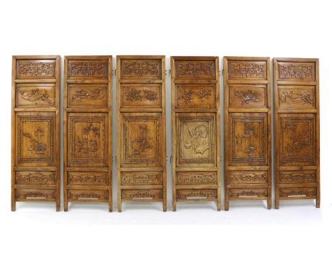 A set of Chinese six-fold wood screens, Qing dynasty (1644-1911), each carved with precious objects within a key fret border,