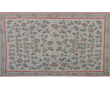 A large Indian needlepoint carpet, cream ground with various green and pink flowerhead decoration. 259cm x 364cmCondition rep