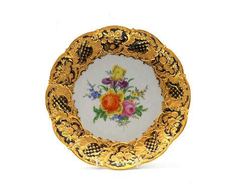 A Meissen porcelain cabinet plate, late 19th/ early 20th century, painted to the centre with flowers, within an elaborately g