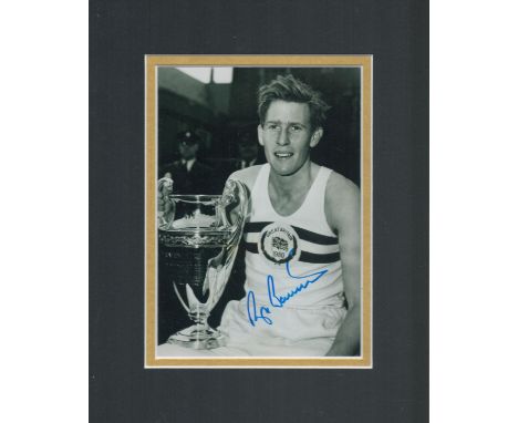 Sir Roger Bannister signed 8 x 8 b/w photo with 1950 Great Britain shirt and silver cup mounted to approx 10 x 8 inches overa