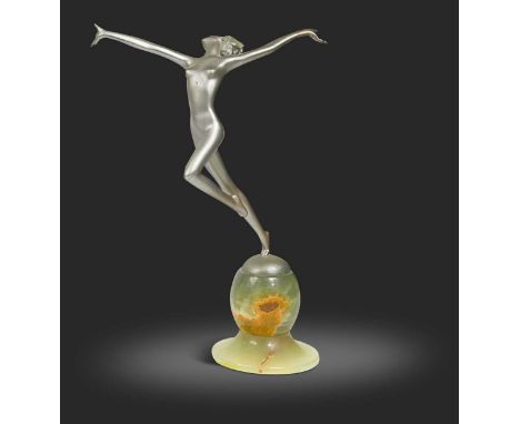 Josef Lorenzl (1892-1950), an Art Deco silvered bronze model of a dancing female nude, mounted to an onyx ball and circular f