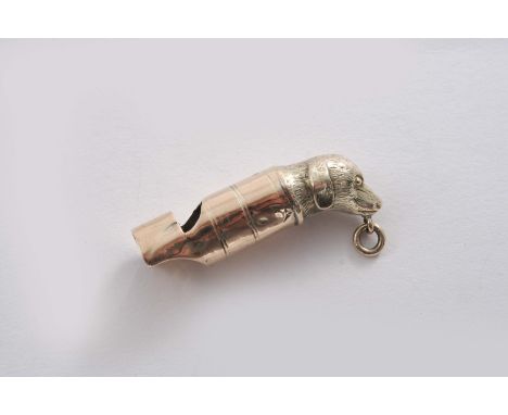 A SMALL EDWARDIAN 9 CT. GOLD WHISTLE  with a dog's mask & ring at one end, maker's mark worn, London 1905;  1.3"  (3.5 cms) l