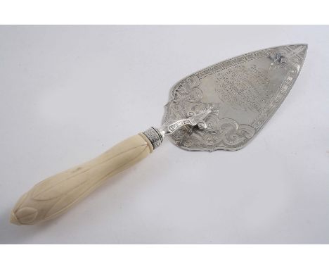 A VICTORIAN ENGRAVED PRESENTATION TROWEL with a carved ivory handle, inscribed, maker's mark "TW", Birmingham 1869;  12.1"  (