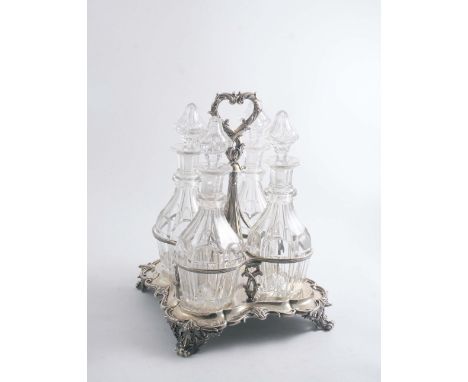 AN EARLY VICTORIAN DECANTER STAND of shaped square outline with a leafy scroll border & foliate ring handle, inscribed in the