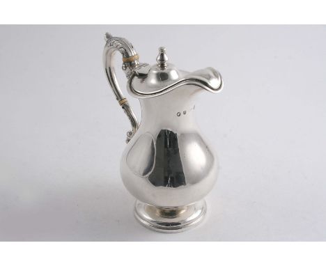 A VICTORIAN SCOTTISH HOT MILK JUG of baluster form with a leaf-capped, S-scroll handle, knop finial & gilt interior, by Robb 