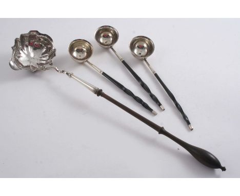 A GEORGE II PUNCH LADLE with a turned wooden handle by William Garrard, London 1748 & three George III toddy ladles with twis