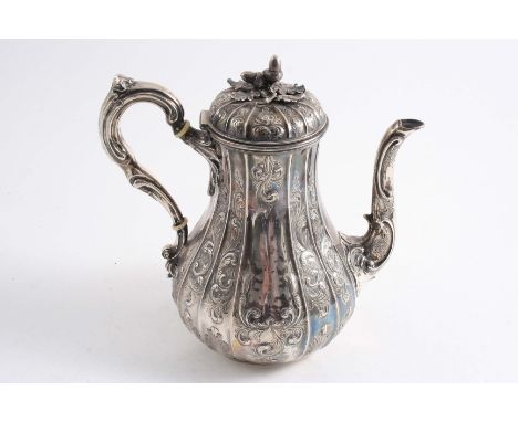 A VICTORIAN COFFEE POT of baluster form with a flat box & scroll handle, decorated with vertical fluting & chased scrollwork,