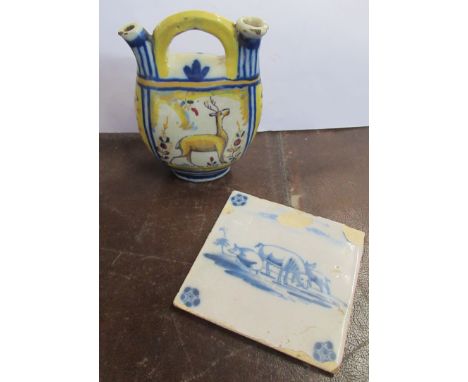 A faience pottery vessel, decorated in polychrome colours, height 6.25ins, together with a Delft tile, decorated with wild pi
