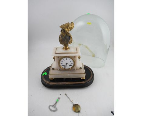 A white marble mantel clock, surrounded by a gilt bust, the movement stamped possibly Marti with a circular inset medal, rais