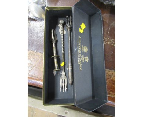 A pickle fork together with two hors d'oeuvres grips&nbsp;