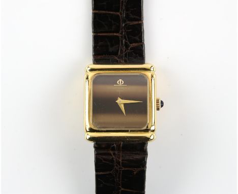 Baume and Mercier,  A ladies gold wristwatch, the tigerseye dial signed at 12, cabochon set crown, fitted with a 550 17 jewel