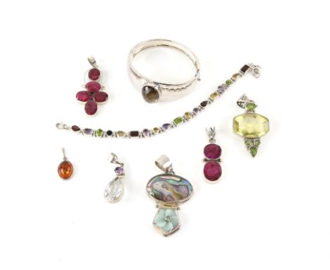 A group of gemstone set silver jewellery, including a Smokey quartz bangle, two ruby set pendants, heat treated amber pendant