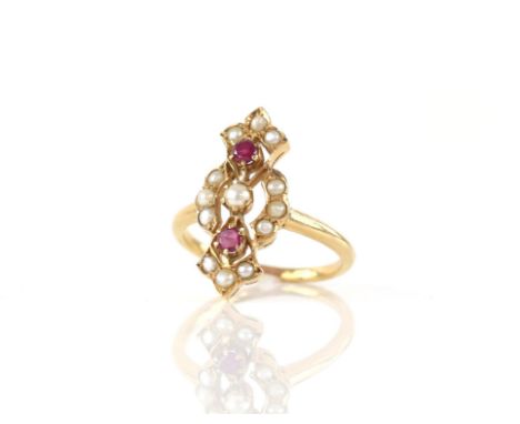 Ruby and pearl dress ring, set with two round cut rubies in a claw setting, with seed pearls, mount testing as 18 ct yellow g