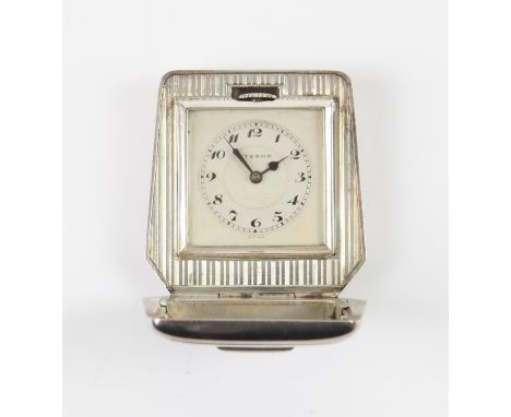 Eterna, a silver cased travel clock, the engine turned case opening to reveal  a square faced dial in stepped mount, the silv