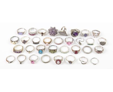 A collection of thirty-three rings, set with gemstones and Cubic zirconia's, including a four stone set ruby ring, size R, a 