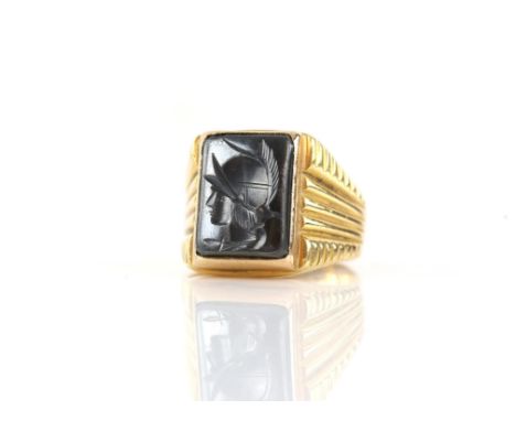 Hematite signet ring, with central rectangular hematite with intaglio engraving of a roman warrior, in a heavy mount, in test
