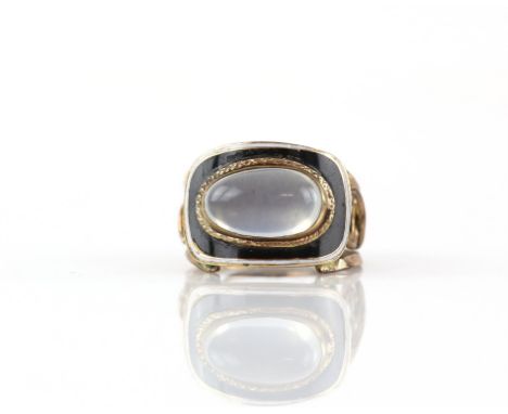 Georgian moonstone ring, oval cabochon cut moonstone, set in a gold textured frame, surrounded by a boarder of black and whit