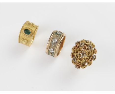 Three rings, including a Etruscan style emerald cabochon ring, in a rub over setting, in tested 18 ct yellow gold, size K, wi